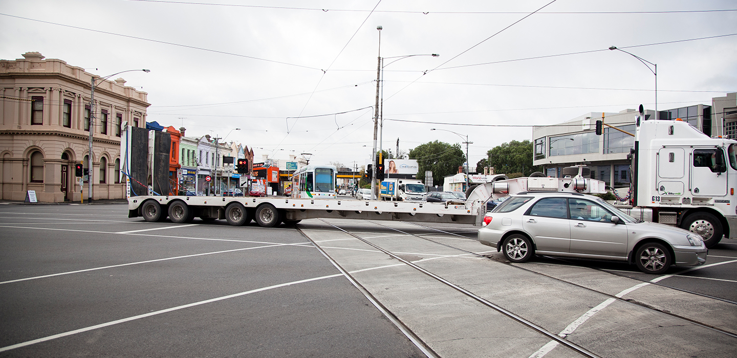 A car and truck turning right across an intersection